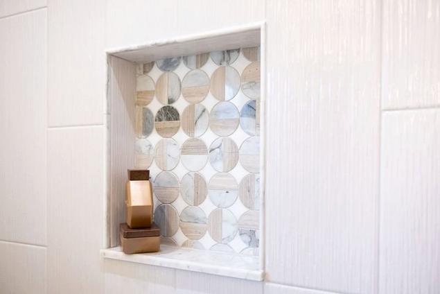 Close-up of primary bathroom's marble mosaic shower niche.